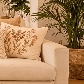 A tall, lush Areca palm plant in a natural woven basket, providing a vibrant green accent to the living room.